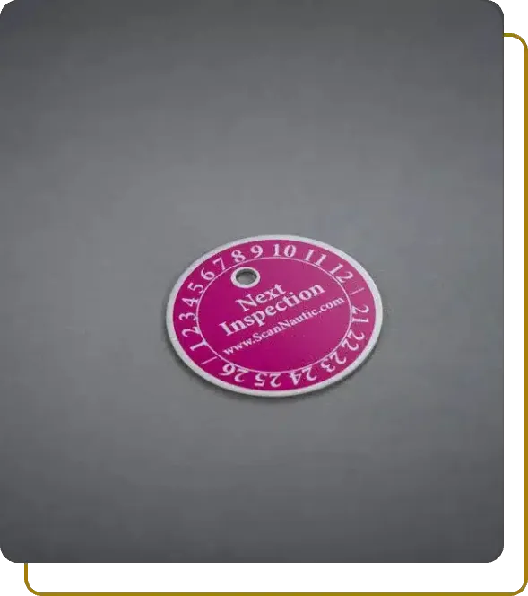 Round aluminum safety tag for ScanNautic with pink background and year/month dial for next inspection tracking.