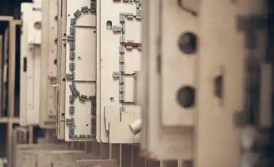 Industrial die cutting process shaping custom metal tags and components.