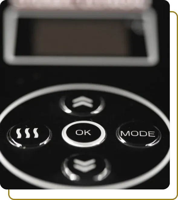 Vertical close-up of a black control panel overlay featuring high-gloss embossed buttons for 'OK', 'MODE', and heating functions.